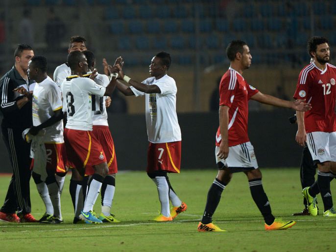Ghana's players (L) celebrate following their victory over Egypt in their WC2014 African zone qualifier second leg football play-off, at the 30 June Air Defence Stadium in Cairo, on November 19, 2013. Ghana qualified for a third successive World Cup, securing their ticket to Brazil with a 7-3 aggregate win over Egypt. AFP PHOTO / KHALED DESOUKI