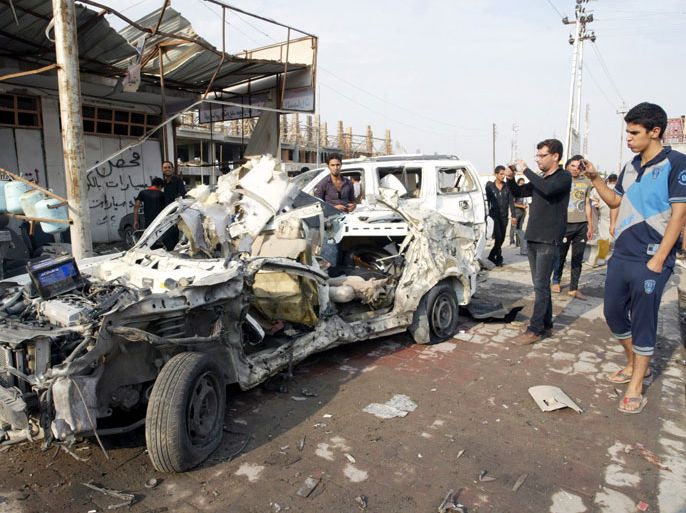 Iraqis at the scene of a car bomb attack in Basra, Iraq, 10 November 2013. At least 12 people were killed and dozens were wounded in a wave of attacks in north and south of Iraq. EPA/STR