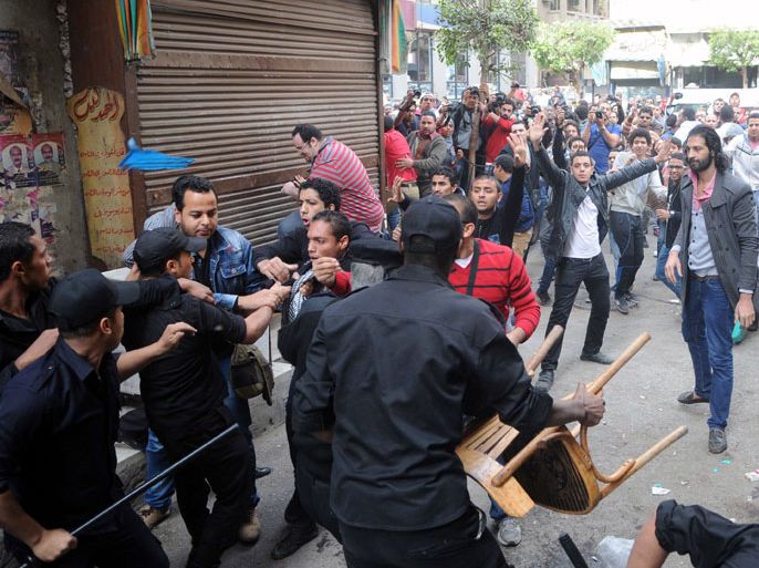 Egyptian security forces clash with protesters who gathered in support of a prominent secular activist who turned himself after being ordered detained for holding a demonstration against a new protest law, on November 30, 2013 in the Egyptian capital, Cairo. Ahmed Maher, founder of the April 6 movement, one of the main groups that spearheaded the 2011 revolt against long-time ruler Hosni Mubarak, arrived at a Cairo court surrounded by dozens of supporters who chanted slogans demanding the release of other detained activists. AFP PHOTO STR