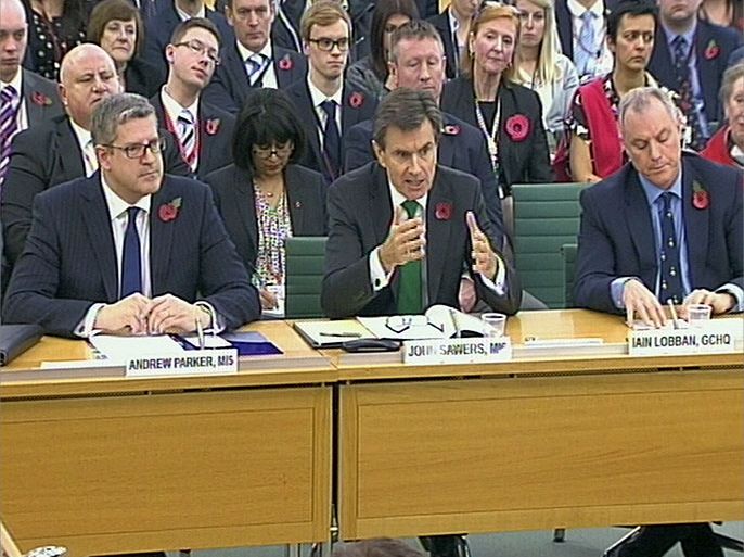 epa03940160 A TV grab image showing (L-R); The Director-General of security service MI5, Andrew Parker, the Chief of the Secret Intelligence Service, Sir John Sawers and Director of GCHQ Sir Iain Lobban talk at the first parliamentary Intelligence and Security Committee (ISC) in London, Britain, 07 November 2013. Their appearance at Westminster comes amid intense debate over the role of the agencies following the disclosures by the former US intelligence operative, Edward Snowden, of the surveillance activities of GCHQ and its American counterpart, the National Security Agency (NSA). EPA/PA WIRE UK AND IRELAND OUT ** PARBUL ** EDITORIAL USE ONLY/NO SALES
