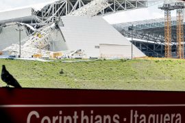 View of damages at the Arena de Sao Paulo --Itaquerao do Corinthians-- stadium, still under construction, after a crane fell across part of the metallic structure, on November 27, 2013 in Sao Paulo. Two people died and another was injured following the accident on the stadium that will host the opening match of Brazil 2014 FIFA World Cup. AFP PHOTO / Miguel SCHINCARIOL