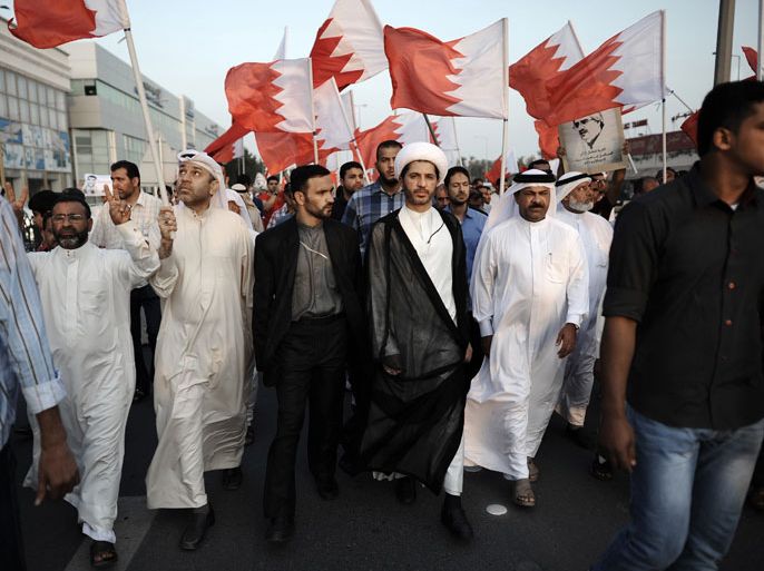 Bahrain's Al-Wefaq opposition group leader Sheikh Ali Salman (C) takes part in an anti-government protest in the village of Bilad al-Qadeem, in a suburb of the capital Manama, on November 22, 2013. Thousands of Shiites in Bahrain took to the streets south of Manama to protest against what they called repression of the opposition, witnesses said. AFP PHOTO