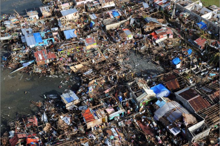 TOPSHOTSThis aerial photo shows destroyed houses in the town of Guiuan in Eastern Samar province, central Philippines on November 11, 2013, four days after devastating Typhoon Haiyan hit the country. Philippines rescue workers struggled to bring aid to famished and destitute survivors on November 11 after the super typhoon that may have killed more than 10,000 people, in what is feared to be the country's worst natural disaster. AFP PHOTO / TED ALJIBE