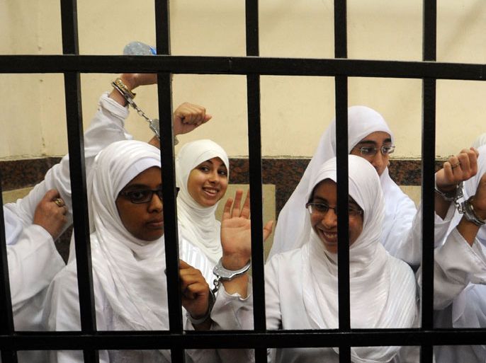 Alexandria, -, EGYPT : Female members of the Muslim Brotherhood are seen during their trial in the Egyptian city of Alexandria on November 27, 2013. A court in the Mediterranean city sentenced 14 women who it said were from the Brotherhood after convicting them of belonging to a "terrorist organisation," judicial sources said. AFP PHOTO/STR