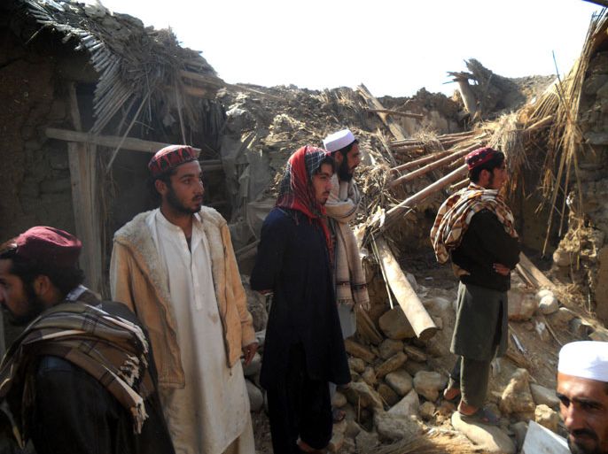 Pakistani Islamic students gather at the destroyed religious seminary belonging to the Haqqani network after a US drone strike in the Hangu district of Khyber Pakhtunkhwa province on November 21, 2013. A US drone killed six people in northwest Pakistan in only the second such strike outside the country's lawless tribal districts, threatening to inflame tensions between Washington and Islamabad. AFP PHOTO/SB SHAH