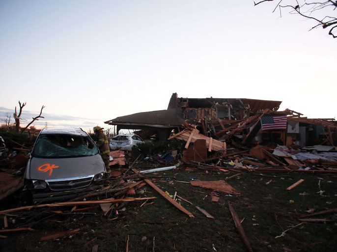 Washington, IL, UNITED STATES : WASHINGTON, IL - NOVEMBER 17: A firefighter searches through debris after a tornado struck on November 17, 2013 in Washington, Illinois. Several tornadoes touched down across the Midwest today with at least three people reported dead in Illinois. Tasos Katopodis/Getty Images/AFP