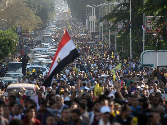EGYPT : Supporters of ousted president Mohamed Morsi and the Muslim brotherhood march through the streets of Cairo's eastern Nasr City district on November 22, 2013. A young boy was killed as supporters and opponents of ousted president Mohamed Morsi fought in Suez city, and police fired tear gas elsewhere to quell disturbances, officials said. Confrontations came as pro-Morsi groups called for a week of anti-military demonstrations under the slogan "Massacre of the Century." AFP PHOTO/MOHAMED EL-SHAHED