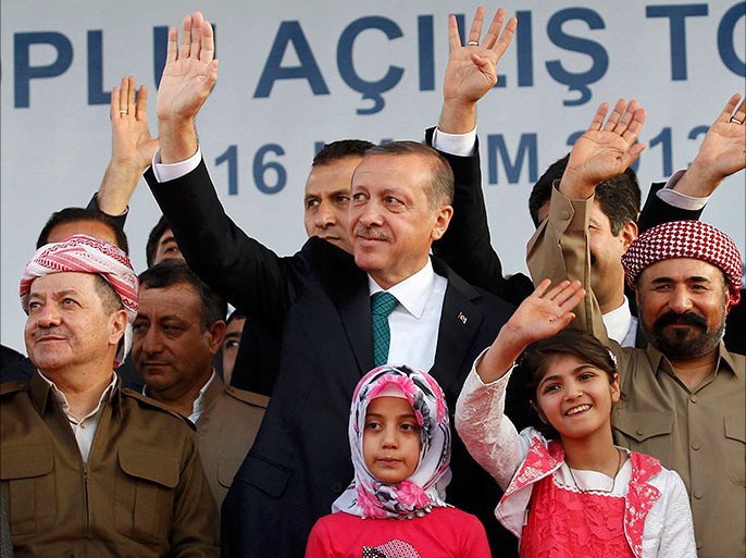 Turkey's Prime Minister Tayyip Erdogan, President of Iraqi Kurdistan Masoud Barzani (L) and Kurdish poet and singer Sivan Perwer (R), who had fled Turkey in the 1970s, greet people, as they are flanked by politicians and chidren during a ceremony in Diyarbakir November 16, 2013. The president of Iraqi Kurdistan called on Turkey's Kurds to back a flagging peace process with Ankara on Saturday, making his first visit to southeastern Turkey in two decades in a show of support for Prime Minister Tayyip Erdogan. Masoud Barzani's trip to Diyarbakir, the main city in Turkey's Kurdish-dominated southeast, comes as Ankara finalises billions of dollars of energy deals with his semi-autonomous region and amid mutual concern over the ambitions of Kurdish militias in the chaos of neighbouring Syria. REUTERS/Stringer (TURKEY - Tags: POLITICS ENTERTAINMENT)