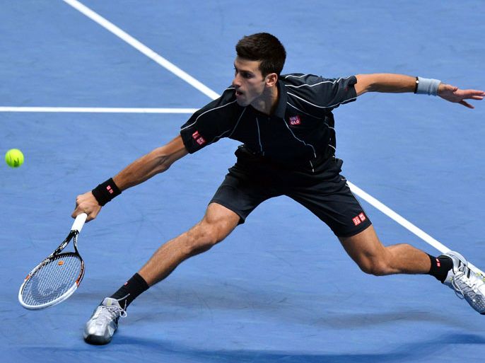 Serbia's Novak Djokovic returns against Switzerland's Roger Federer during his group B singles match in the round robin stage on the second day of the ATP World Tour Finals tennis tournament in London on November 5, 2013. AFP PHOTO / BEN STANSALL