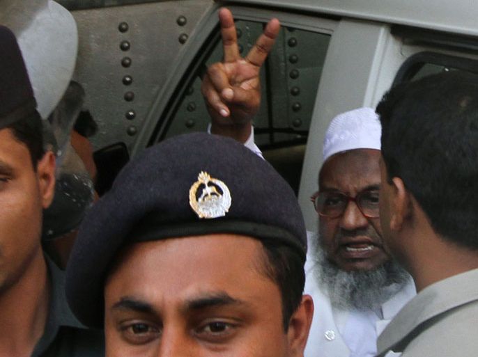 Dhaka, -, BANGLADESH : (FILES) In this photograph taken on February 5, 2013, Abdul Quader Molla (R) the fourth-highest ranked leader of the Jamaat-e-Islami party, gestures at the central jail in Dhaka. Bangladesh's highest court held a hearing on December 10, 2013, to decide the fate of a leading Islamist leader sentenced to death for war crimes who was saved from the gallows by a dramatic last-gasp intervention. A judge stayed the hanging of Jamaat-e-Islami party leader Abdul Quader Molla just 90 minutes before his scheduled execution overnight at a jail in the capital Dhaka. AFP PHOTO/STR/FILES