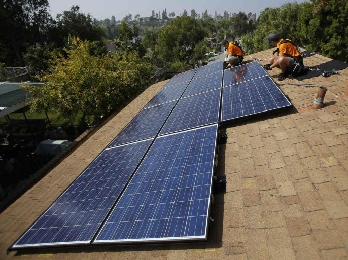 Vivint Solar technicians install solar panels on the roof of a house in Mission Viejo, California, in this October 25, 2013 file photo. A small army of salesmen pitch Vivint Solar, the fast-growing rooftop solar installation and financing business owned by Blackstone Group LP. The startup, founded by an entrepreneur and former Mormon missionary, finds members of The Church of Jesus Christ of Latter-day Saints who knocked on doors as part of their own missions are among its best salespeople, making up about half the salesforce. To match Feature BLACKSTONE-VIVINTSOLAR.