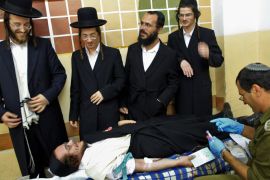 Ultra-Orthodox Jews donating blood during a military exercise carried out by the Israeli Home Front Command in the relgiious neighborhood of Mea Shearim in Jerusalem, Israel on 22 October 2009. Many ultra-Orthodox Jews have deferments to serve in the Israeli military, where more secular Israeli males all must serve three years directly after high school. The are however some army units entirely made up of Orthodox, religious Jews. EPA/NATI SHOHAT **ISRAEL OUT**