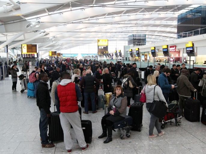 Passengers queue at the flight check-in desk at London's Heathrow Airport Terminal 5 after a "technical problem" at the National Air Traffic Services (Nats) control centre in Swanwick, south England, caused long delays and cancellations at airports across the UK, Saturday Dec. 7, 2013. Engineers are trying to fix the problem, but gave no time estimate, according to The Association of British Travel Agents, as scores of flights were delayed or canceled at Britain's busiest airports Saturday because of a technical problem at a main air traffic control center. (AP Photo/Steve Parsons, PA) UNITED KINGDOM OUT - NO SALES - NO ARCHIVES