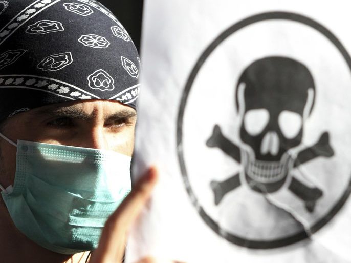 A demonstrator protests against the dismantling of Syrian chemical weapons in Albania in front of the Prime Minister's office in Tirana in this November 7, 2013 file photo. Washington wanted Albania, a NATO ally of 2.8 million people, to host the destruction of 1,300 tonnes of Syrian nerve agents under a plan agreed with Russia to eliminate them from Syria's civil war. At the last minute, with protests building, Albanian Prime Minister Edi Rama said that "It is impossible for Albania to take part in this operation". Albania's sudden refusal left U.S. diplomats scrambling for a Plan B to get the chemical weapons out of Syria within six weeks under a timetable agreed with President Bashar al-Assad's big-power backer, Russia. To match Insight SYRIA-CRISIS/ALBANIA REUTERS/Arben Celi/Files (ALBANIA - Tags: CIVIL UNREST POLITICS)