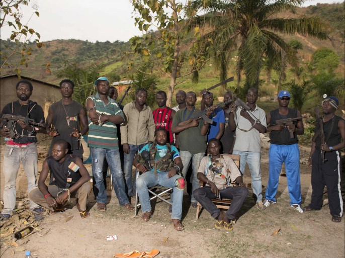 Anti-Balaka Christian militiamen pose in the mountains near Bangui on December 29, 2013. The United Nations said December 27 it would speed up planning for a possible UN peacekeeping force in the strife-ridden Central African Republic, as French troops there sought to clamp down on violence. More than 1,000 people are believed to have been killed in three weeks of sectarian violence in Bangui alone. AFP PHOTO / MIGUEL MEDINA
