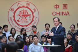 Shanghai, Shanghai, CHINA : This picture taken on December 3, 2013 shows British Prime Minister David Cameron (R) delivering a speech at Shanghai Jiao Tong University in Shanghai. Britain should recognise it is not a big power but "just an old European country apt for travel and study", Chinese state-run media snapped on December 3 as Cameron visited. CHINA OUT AFP PHOTO