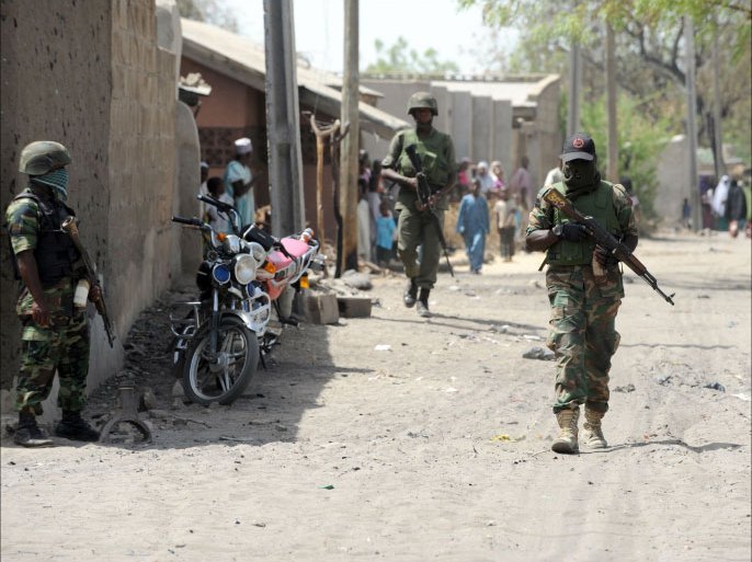 FILES) -- A file photo taken on April 30, 2013 shows soldiers walking in the street in the remote northeast town of Baga, Borno State. Attacks by Islamist group Boko Haram in Nigeria's restive northeast have killed more than 1,200 people