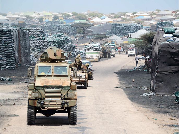(FILES) - A photo taken on February 27, 2013 shows Kenyan convoys patrolling near Kismayo seaport. Battles between rival warlords in Somalia's key southern port city of Kismayo killed at least 71 people last month, UN officials said on July 5, 2013, clashes Mogadishu has accused Kenyan troops of encouraging. AFP PHOTO / MOHAMED ABDIWAHAB