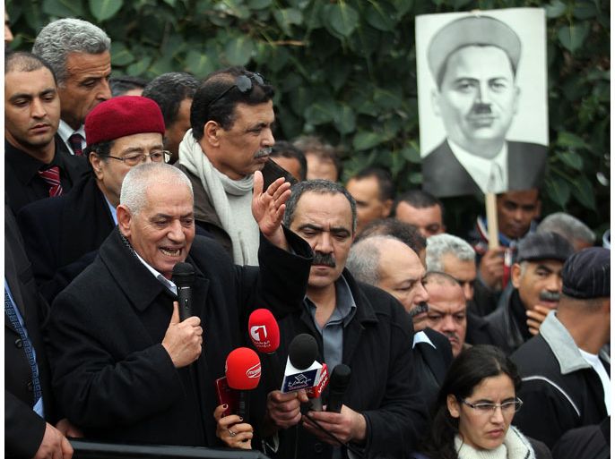 epa03976575 Secretary General of the Tunisian General Labor Union (UGGT) Houcine Abassi (L) speaks to supporters marking the 61st anniversary of the assassination of union leader Farhat Hached (poster on R), in Tunis, Tunisia, 04 December 2013. Hached was one of the main leaders of the national movement alongside figures like Habib Bourguiba. His assassination on 05 December 1952 was attributed to Red Hand, a pro-French Tunisia armed organization. EPA/MOHAMED MESSARA