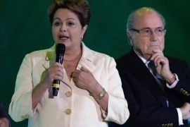 Brazilian President Dilma Rousseff (L) speaks next to FIFA President Joseph Blatter during the final draw of the Brazil 2014 FIFA World Cup, in Costa do Sauipe, Bahia state, Brazil, on December 6, 2013. Thirty-two teams will learn their World Cup fate when the draw for Brazil's problem-plagued 2014 showpiece takes place today. AFP PHOTO / VANDERLEI ALMEIDA