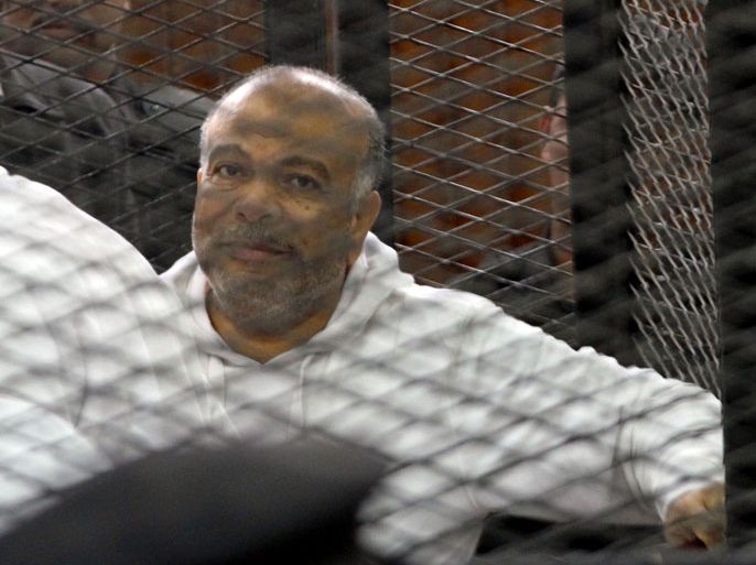 Egyptian Muslim Brotherhood senior member Saad al-Katatni is seen inside the defendant's cage during his trial in the police institute near Cairo's Turah prison on December 11, 2013. The trial of Egypt's Muslim Brotherhood chief Mohamed Badie and his deputies on charges related to protest deaths came to an abrupt end when the judges walked out, citing chaos in the dock. AFP PHOTO/MAHER ISKANDER