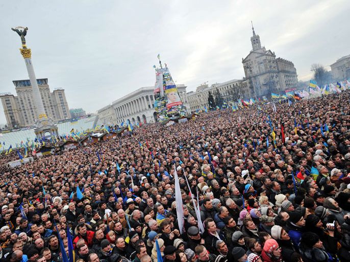 Ukrainian opposition supporters gather at a mass rally on Independence Square in Kiev, on December 15, 2013. The European Union suspended association talks with Ukraine as more than 200,000 protesters massed in the heart of Kiev demanding that the government recommit itself to the West. The ex-Soviet nation of 46 million has been at the heart of a furious diplomatic tug of war since President Viktor Yanukovych's surprise decision last month to ditch a landmark EU agreement and seek closer ties with historic master Russia. AFP PHOTO/GENYA SAVILOV
