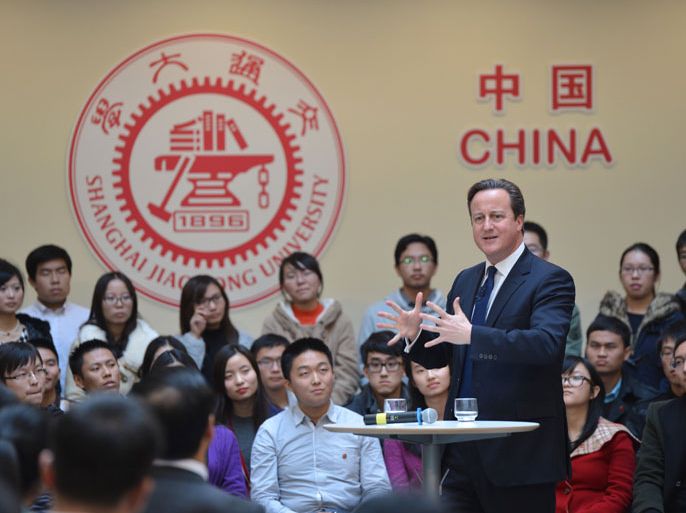 Shanghai, Shanghai, CHINA : This picture taken on December 3, 2013 shows British Prime Minister David Cameron (R) delivering a speech at Shanghai Jiao Tong University in Shanghai. Britain should recognise it is not a big power but "just an old European country apt for travel and study", Chinese state-run media snapped on December 3 as Cameron visited. CHINA OUT AFP PHOTO