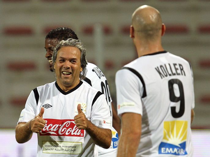 epa02996631 Algerian player Rabah Madjer (L) and Czech Republic player Jan Koller (R) in action during a Charity Soccer Match "Friends of Libya's Children" in Dubai, United Arab Emirates, 08 November 2011. The match in the United Arab Emirates aims to offer its support in constructing the future of a nation, Libya, as it tries to return to a normal way of life. Two all-star teams, brought together by Al Ahli and UAE Red Crescent, were playing and led by Marcello Lippi and Walter Zenga. EPA/ALI HAIDER