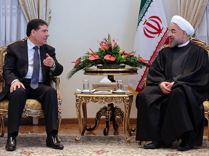 Iranian President Hassan Rouhani (R) meets with Syrian Prime Minister Wael al-Halaqi in Tehran on December 1, 2013.