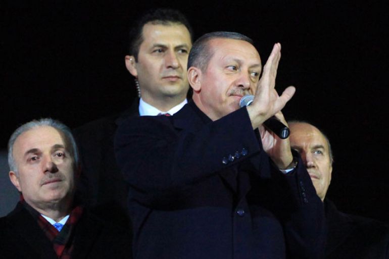 Turkish Prime Minister Recep Tayyip Erdogan waves at supporters during a rally at Esenboga Airport in Ankara on December 27, 2013. Erdogan was being battered on all fronts on December 27, as a graft scandal savaging his government sparked party resignations, fresh street protests and pushed the currency to a record low. AFP