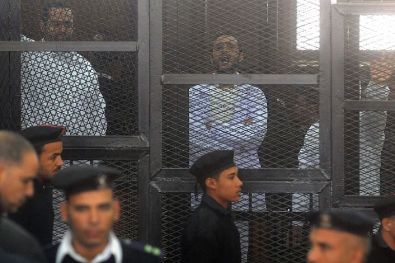 Egyptian activicts Mohamed Adel (L), Ahmed Douma (C) and Ahmed Maher (R) stand in the accused dock during their trial on December 22, 2013 in the capital Cairo. An Egyptian court sentenced three activists who spearheaded the 2011 uprising against Hosni Mubarak to three years in jail for organising an unlicensed protest, judicial sources said. It was the first such verdict against non-Islamist protesters since the overthrow of president Mohamed Morsi in July, and was seen by rights groups as part of a widening crackdown on demonstrations by military-installed authorities. AFP PHOTO/STR