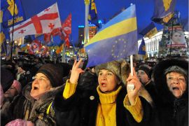 AFP-Protesters wave flags as they take part in an opposition rally on Independence Square in Kiev on December 7, 2013.