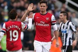 Arsenal’s French striker Olivier Giroud (R) celebrates with Arsenal's Spanish midfielder Santi Cazorla (L) after scoring the opening goal during the English Premier League football match between Newcastle United and Arsenal at St James' Park in Newcastle upon Tyne, northeast England on December 29, 2013. AFP PHOTO / IAN MACNICOL