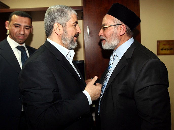 epa03071589 A handout photograph released by the Hamas Press Office shows Egyptian Mohamed Badie (R) leader of the Muslim Brotherhood greeting Palestinian Hamas leader Khaled Meshaal in Cairo, Egypt, 21 January 2012 . EPA/MOHAMED HAMS HANDOUT EDITORIAL USE ONLY/NO SALES