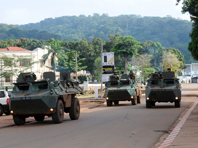 French soldiers patrol on tanks in front of the Presidential Palace in Bangui, Central African Republic, on December 7, 2013. French troops could be seen arriving on December 7 in the Central African Republic from Cameroon as part of a UN effort to help restore security in the strife-torn country. AFP