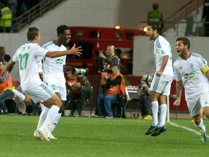 Morocco Raja Casablanca's players celebrate after scoring a goal against Mexic's CF Monterrey during their FIFA Club World Cup quarter final football match in the coastal Moroccan city of Agadir on December 14, 2013. AFP PHOTO / FADEL SENNA