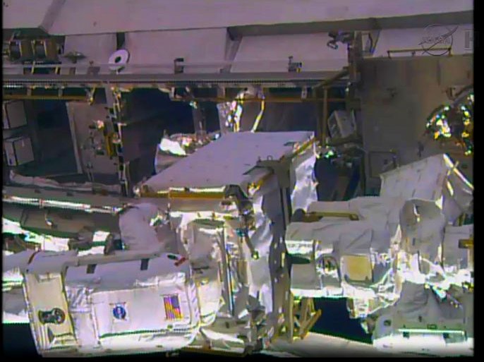 This December 21, 2013 NASA TV still image shows the International Space Station during an spacewalk by NASA astronauts Rick Mastracchio and Mike Hopkins to remove a faulty ammonia pump on the ISS. A second spacewalk to install a new unit now is scheduled for December 24. The extra day will allow time for the crew to resize a spare spacesuit on the space station for use by Mastracchio. During repressurization of the station’s airlock following the spacewalk, a spacesuit configuration issue put the suit Mastracchio was wearing in question for the next excursion -- specifically whether water entered into the suit’s sublimator inside the airlock. The flight control team at NASA's Johnson Space Center in Houston decided to switch to a backup suit for the next spacewalk. One of the astronauts can be seen at the lower left. AFP PHOTO