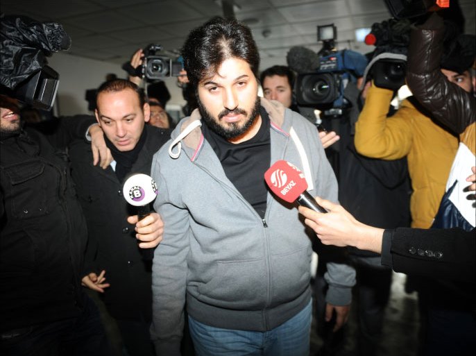 Detained Azerbaijani businessman Reza Zarrab (C) is surrounded by journalists as he arrives at a police center in Istanbul on December 17 ,2013. Turkish police detained more than 20 people including the sons of three cabinet ministers and several high-