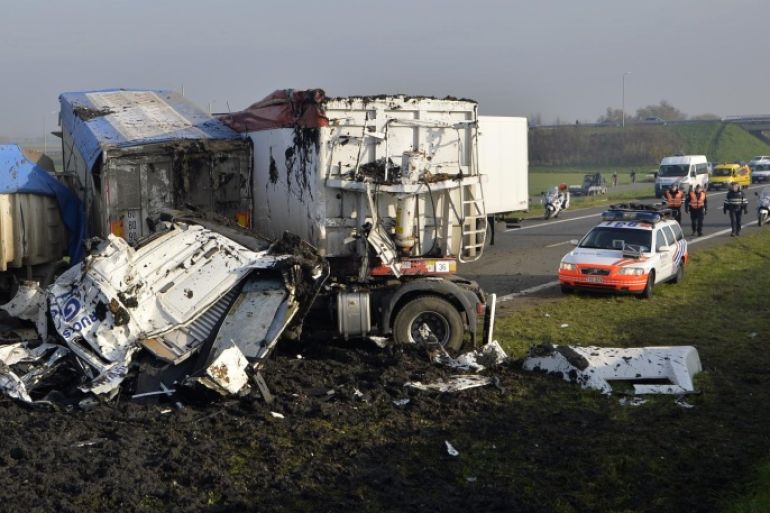 A picture shows wrecked cars at the site of a multiple collision accident on highway A19 towards Kortrijk near Zonnebeke-Beselare on December 3, 2013. At least one person was killed in the accident, which involved 40 to 50 vehicles, blocking the motorway in both directions. The accident was caused by dense fog. AFP PHOTO/BELGA/ERIC LALMAND == BELGIUM OUT ==