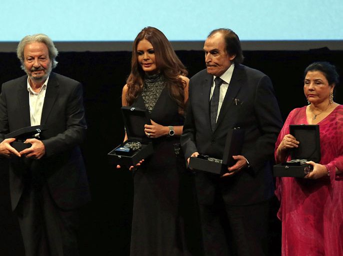 epa03979879 (L-R) Syrian filmmaker Mohammed Malas, Lebanese actress Carmen Lobos, Egyptian actor Ezzat el-Alayli and Tunisian film director Mufida Tlatli pose with their awards during the opening ceremony of the 10th Dubai International Film Festival (DIFF) 2013 in Gulf emirate of Dubai, United Arab Emirates, 06 December 2013. The DIFF runs from 06 until 14 December. EPA/ALI HAIDER