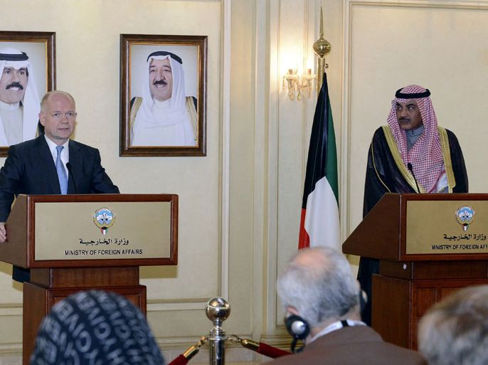 British Foreign Secretary William Hague speaks during a joint press conference with Kuwaiti Foreign Minister Sheik Sabah Khalid al-Hamad al-Sabah (R) in Kuwait city on December 6, 2013. Hague is on an official visit to Kuwait to discuss bilateral ties and regional developments. On the background portraits of Kuwait's Crown Prince Sheikh Nawaf al-Ahmad al-Sabah (L) and Kuwait's Emir Sheikh Sabah al-Ahmad al-Jaber al-Sabah. AFP
