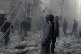 Men are seen near a damaged site after what activists said was an air raid by forces loyal to Syrian President Bashar Al-Assad, in Aleppo&#39;s al-Saliheen district December 23, 2013. More than 300 people have been killed in a week of air raids on the northern Syrian city of Aleppo and nearby towns by President Bashar al-Assad&#39;s forces, a monitoring group said on Monday. Many of the casualties, which included scores of women and children, were killed by so-called barrel bombs dropped from helicopters, the Syrian Observatory for Human Rights said. REUTERS