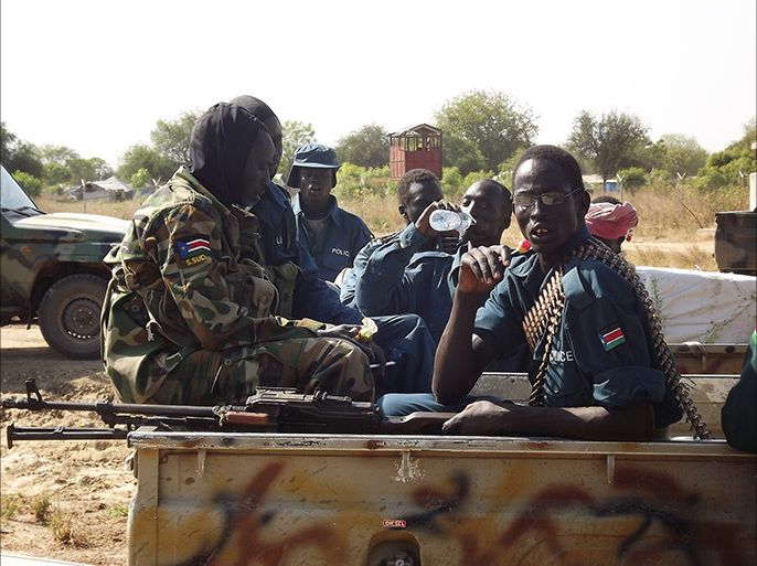 South Sudan army (SPLA) soldiers talk on December 25, 2013 at Bor airport after they re-captured the town from rebels