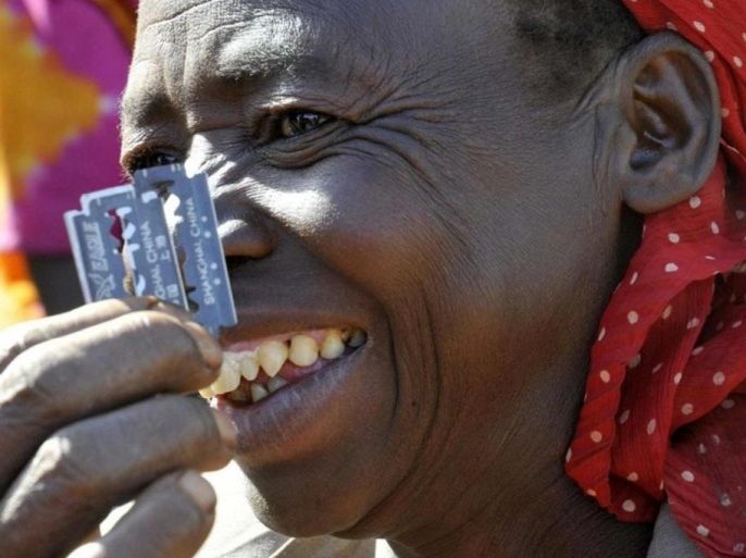 Prisca Korein, a 62-year-old traditional surgeon, displays razor blades she uses to perform female genital mutilation on teenage girls from the Sebei tribe in Bukwa district, about 357 kms (214 miles) northeast of Kampala, December 15, 2008. The ceremony was to initiate the teenagers into womanhood according to Sebei traditional rites.