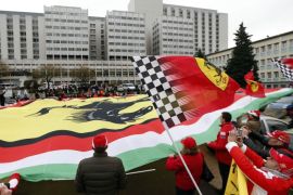 Ferrari fans from France, Italy and Germany display a giant Ferrari flag as they attend a silent 45th birthday tribute to seven-times former Formula One world champion Michael Schumacher in front of the CHU hospital emergency unit in Grenoble, French Alps, where Michael Schumacher is hospitalized January 3, 2014. His agent said on Wednesday that Michael Schumacher was in a stable condition and it was too early to talk about his further prospects. No further update was given on Thursday, the day before his 45th birthday. Schumacher is battling for his life after slamming his head against a rock while skiing off-piste in the French resort of Meribel on Sunday. REUTERS/Charles Platiau (FRANCE - Tags: SPORT MOTORSPORT HEALTH)