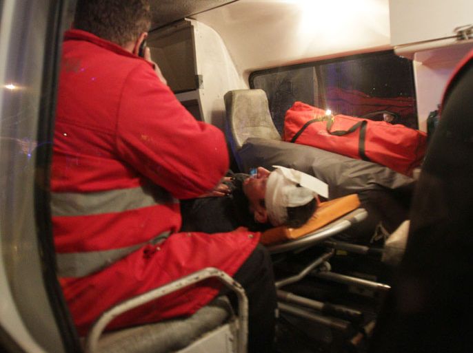 SUP-1947 - Kiev, -, UKRAINE : Ukraine's ex-interior minister and current opposition leader Yuriy Lutsenko lies injured in a ambulance in Kiev, early on January 11, 2014, after being beaten in fresh clashes that erupted between pro-EU demonstrators and club-wielding police during a rally near a district court. Lutsenko was under intensive care in hospital on January 11. Dozens of nationalist demonstrators protested late on January 10 outside a Kiev court that had earlier in the day sentenced three men to six years in prison for allegedly plotting to blow up a statue of Soviet founder Lenin near the city's main airport in 2011. AFP PHOTO / ANATOLII BOIKO