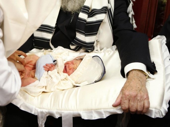 Rabbis perform circumcision on a eight-day-old baby during a ceremony at the European Jewish Community Centre in Brussels, August 20, 2009. In the Jewish religion, it is a tradition to perform circumcision when a boy is eight days old. Picture taken August 20, 2009.