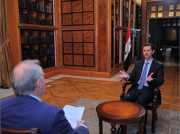 Damascus, -, SYRIA : A handout picture released by the Syrian Presidency Media Office on January 20, 2014 shows Syrian President Bashar al-Assad (R) speaking during an interview with AFP in at the presidential palace in Damascus on the weekend. The Syrian president told AFP in an exclusive interview, days before the beginning of the Geneva II peace talks, that he expected his country's bloody conflict to drag on, describing it as a "fight against terrorism" and rejecting any distinction between opposition fighters and radical jihadists. AFP PHOTO / HO / SYRIAN PRESIDENCY MEDIA OFFICE