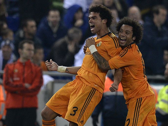 Real Madrid's Portuguese defender Pepe (L) and Real Madrid's Brazilian defender Marcelo (R) celebrate after scoring a goal during the Spanish league football match RCD Espanyol vs Real Madrid at the Cornella-El Prat stadium in Cornella de Llobregat on January 12, 2014.