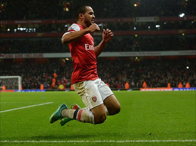 Arsenal's English midfielder Theo Walcott celebrates scoring their second goal during the English Premier League football match between Arsenal and Cardiff City at the Emirates Stadium in London on January 1, 2014. AFP PHOTO/BEN STANSALL